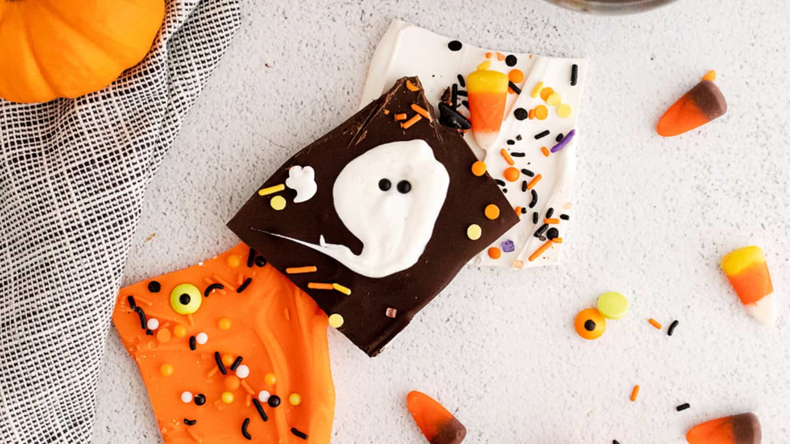 Chocolate bark decorated with white chocolate ghost shapes for Halloween.