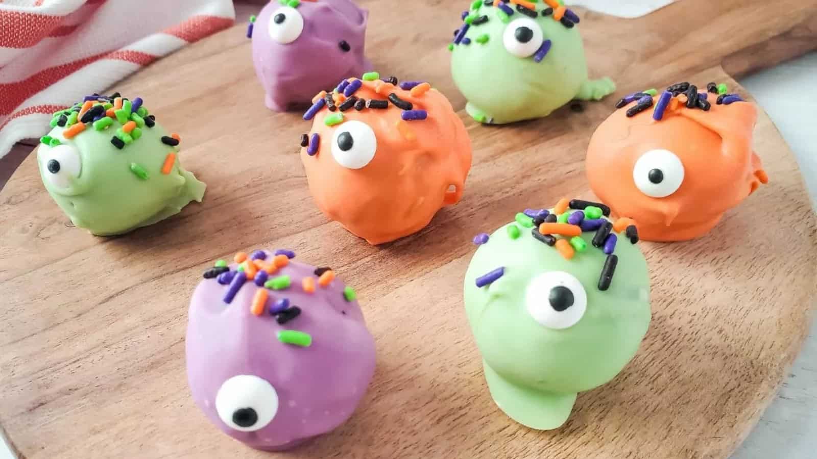 Colorful monster Halloween cookies decorated with candy eyes and sprinkles.