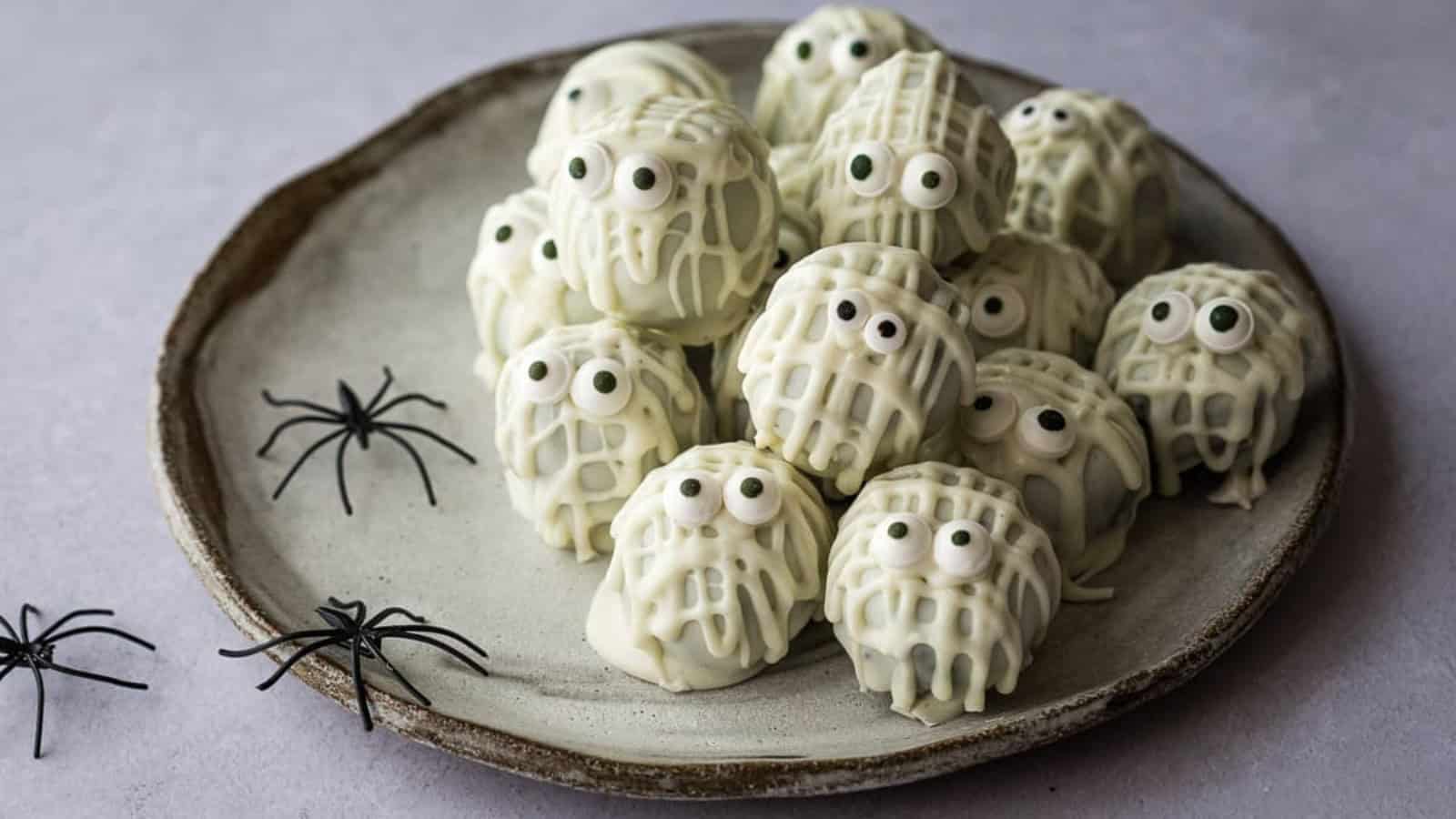 Halloween truffles decorated with festive candy and chocolate.