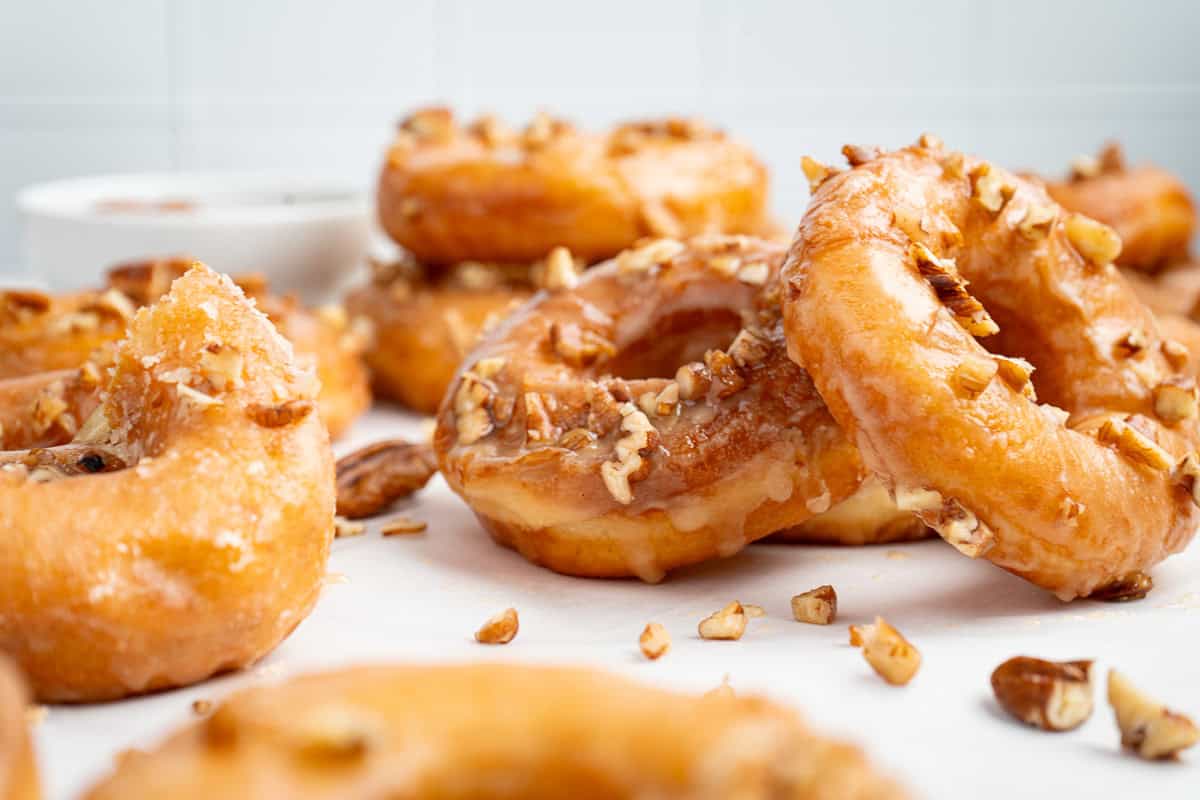 Maple glazed donuts topped with chopped pecans.