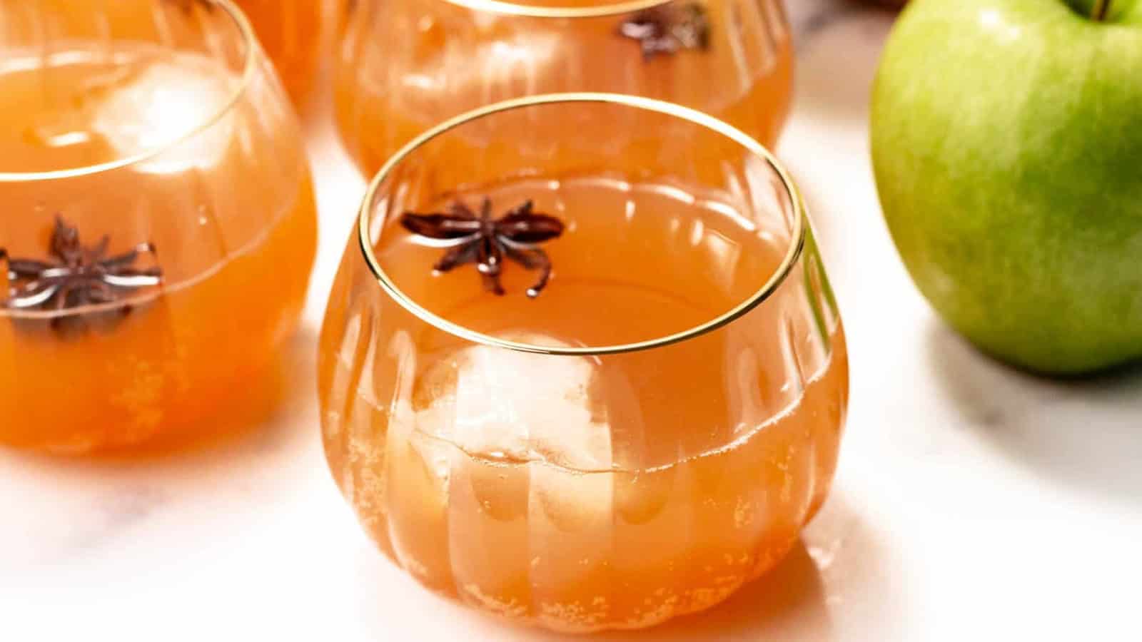 Poison apple Halloween punch with a deep red color and apple garnish.