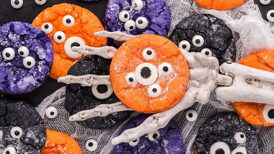Crinkle cookies decorated with colorful candy eyes for a Halloween monster theme.